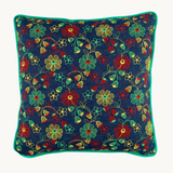 Photo of a vintage floral embroidered cushion, a denim base cloth with naive red, yellow and spearmint green flowers