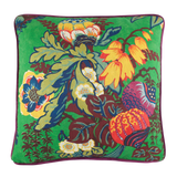 Colorful floral pillow with vibrant patterns on a green background