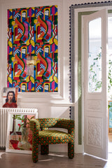 Elegant space with BOSSA NOVA wallpaper, a green patterned chair, framed artwork, ornate white french doors