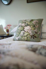 Close up of a vintage linen floral cushion