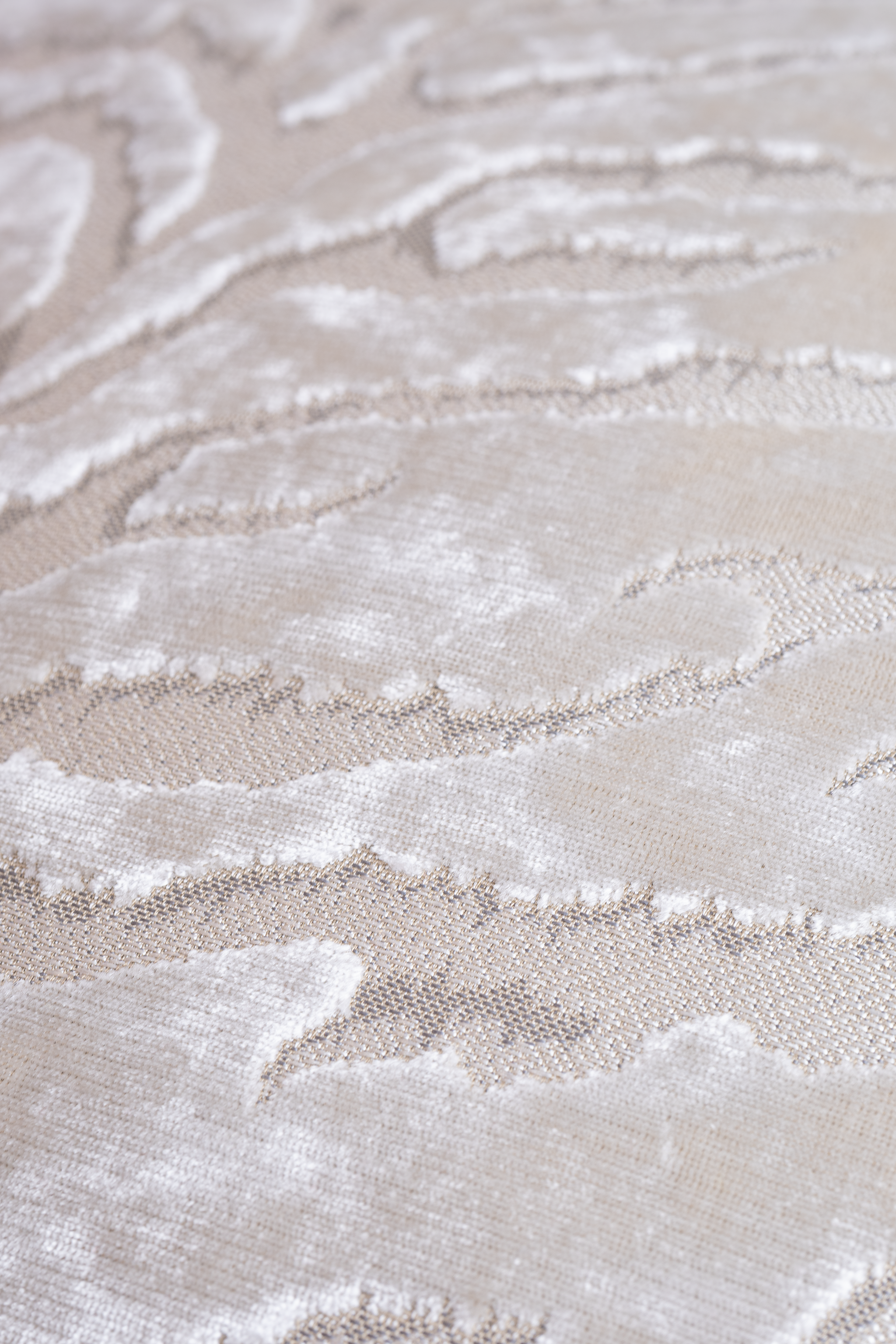 Close up of a lustrous white velvet cushion with a tiger print pattern