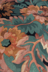 Close-up of a floral pattern with green, orange, and blue colors.