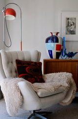 photo of a retro chair with a vintage cushion and other objects d'art