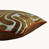 Side photo of a cushion with a retro cut velvet large scale floral design in a rich tan colour