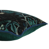 Decorative cushion with a leafy botanical pattern on a black velvet background