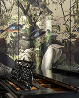 A grand black piano sits before a stunning nature-inspired wallpaper featuring exotic birds, lush greenery, and delicate white florals in an artistic composition.