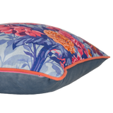 Floral patterned cushion with pink, coral and orange dahlias on a light blue background