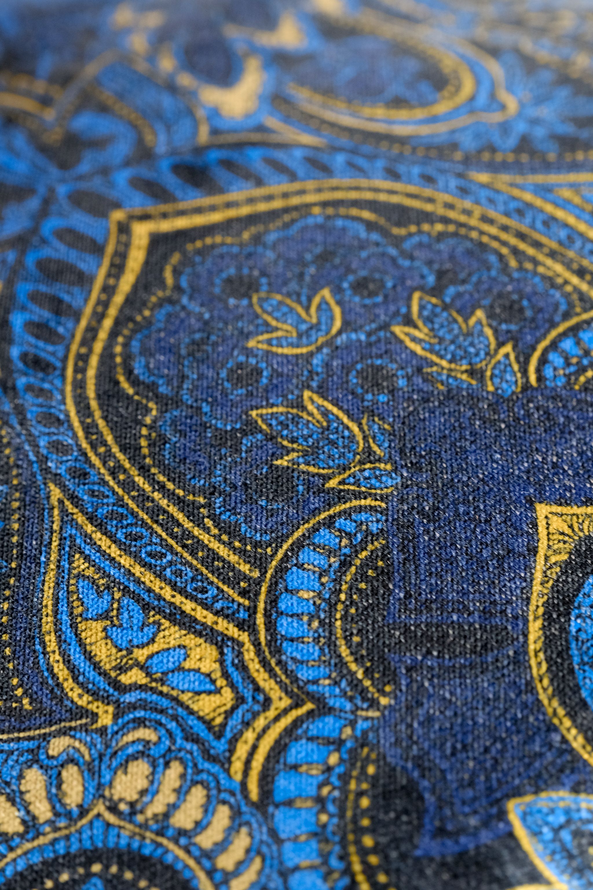 Close up of a printed damask velvet in blue gold and black