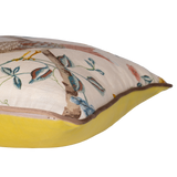 Side view of a decorative cushion with floral and bird design on a linen background
