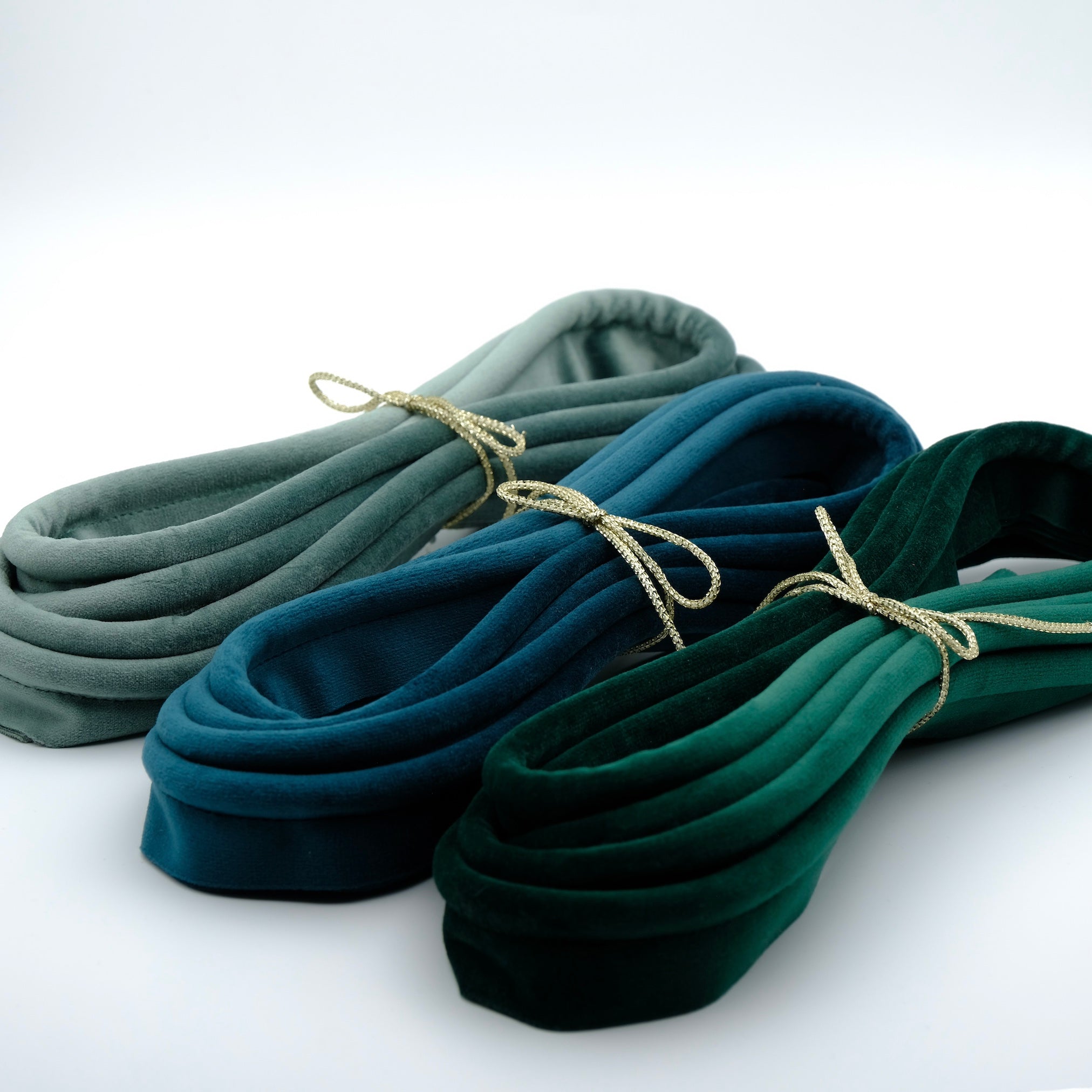 Photo of three bundles of velvet piping cord in shades of green and blue
