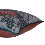 Side shot of a decorative floral cushion with large boquet of flowers in grey pink red navy and aquamarine.