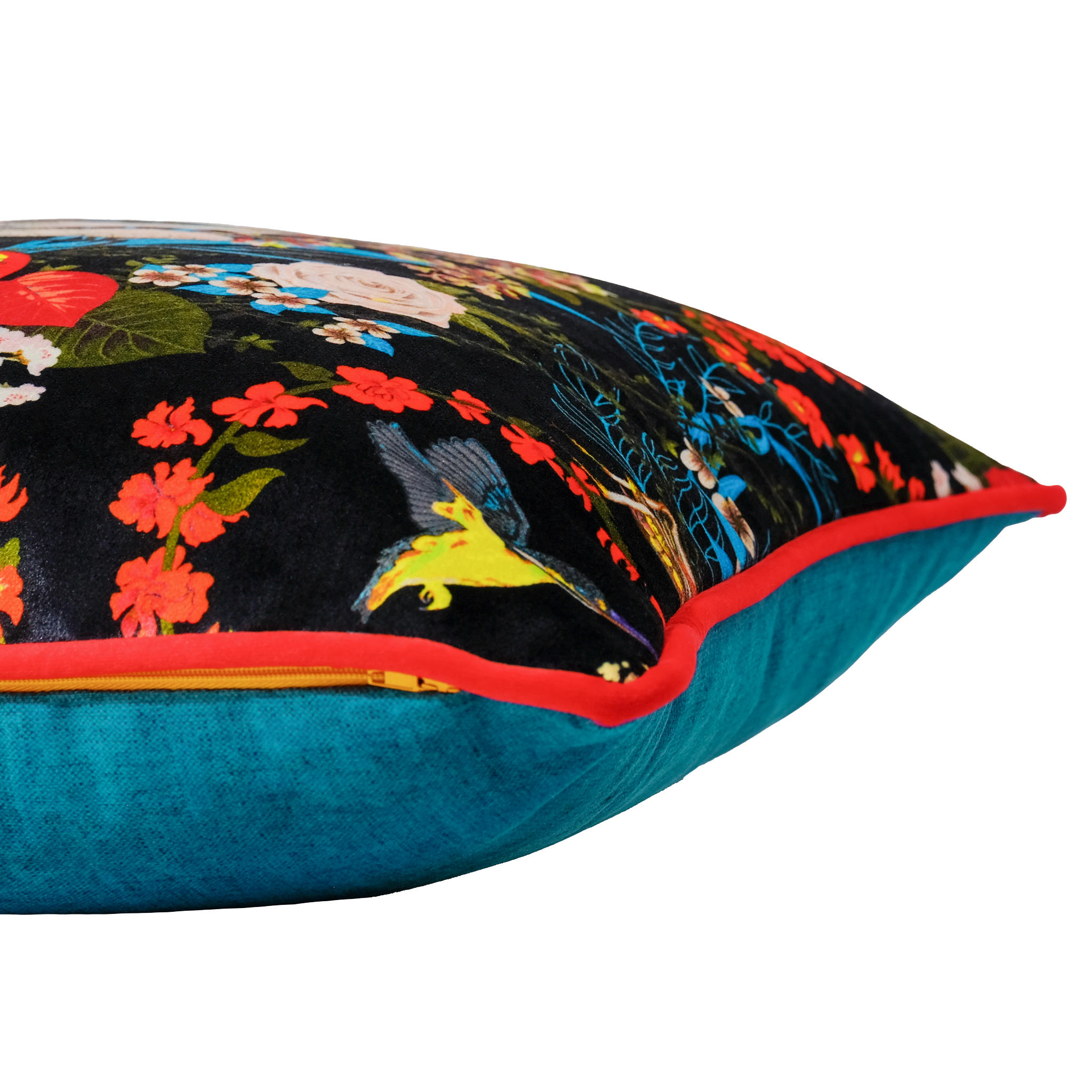 Decorative pillow with colorful floral and animal pattern on a black background, featuring red piping and a teal back.