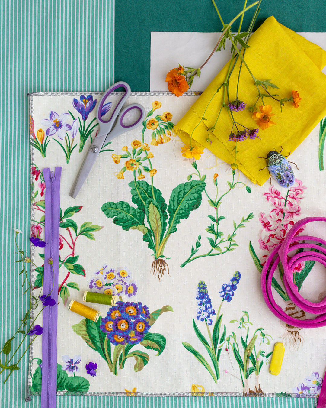 Flatlay of a floral cushion with sewing items