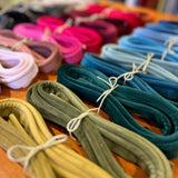 Photograph of a group of bundles of different coloured velvet piping