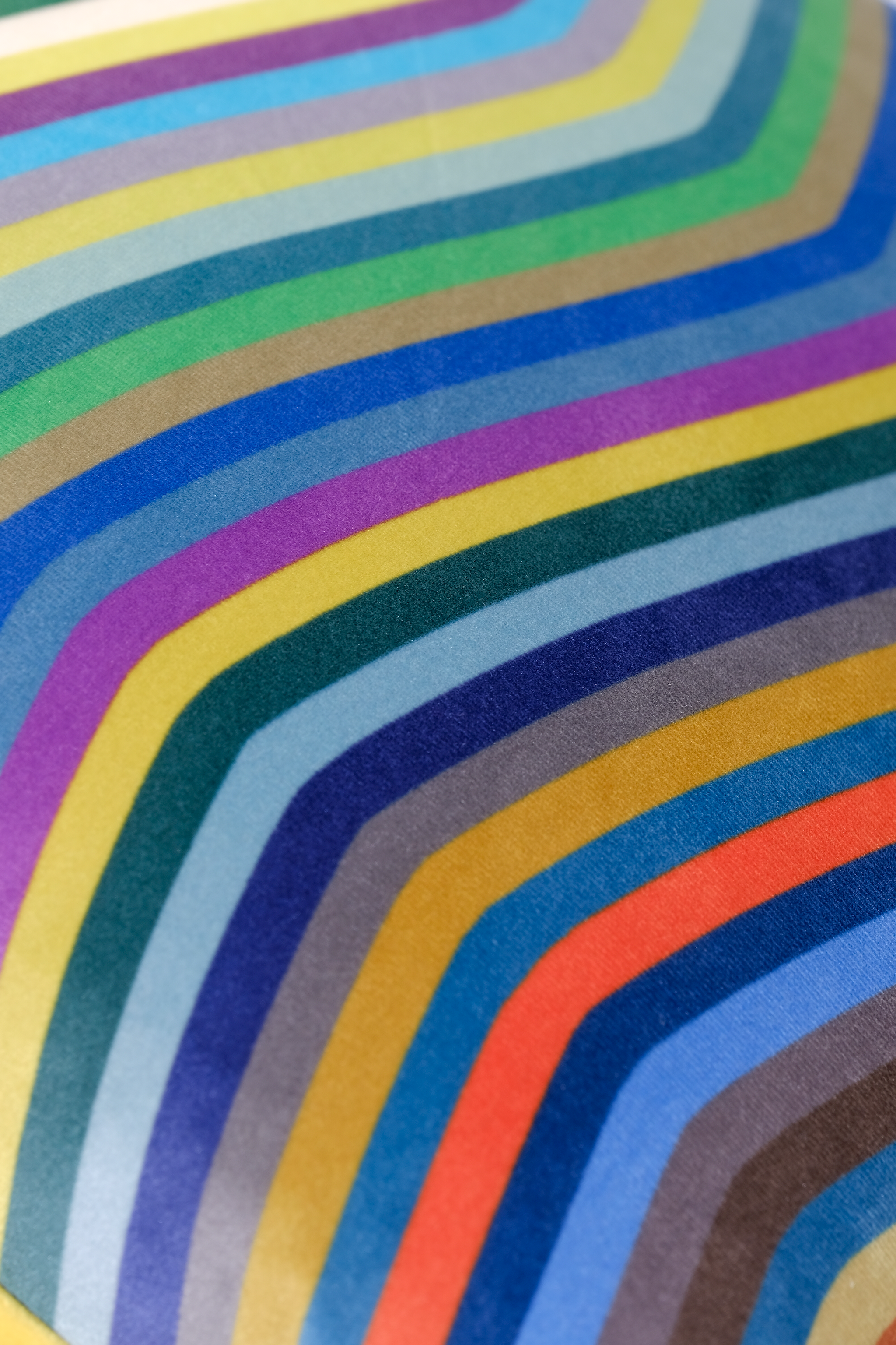 Colorful wavy pattern with a gradient of blue, green, yellow, and red.