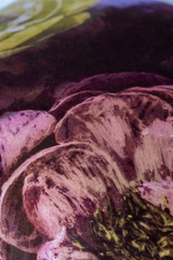 close up of a velvet floral cushion in aubergine gold and pink