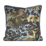 Floral and leaf patterned cushion on a light blue background