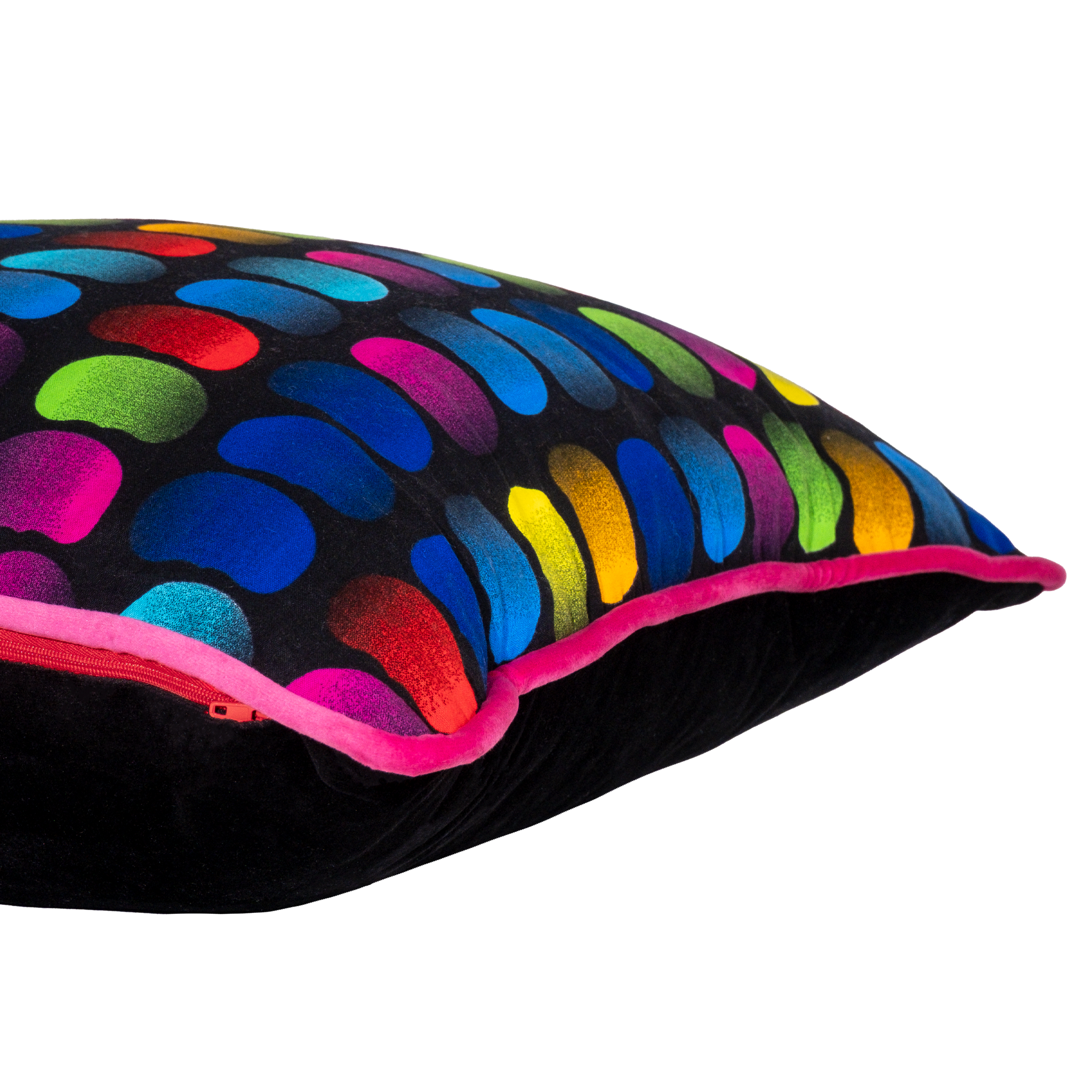 Side view of a neon bright cushion with rainbow of coloured beans on a black background