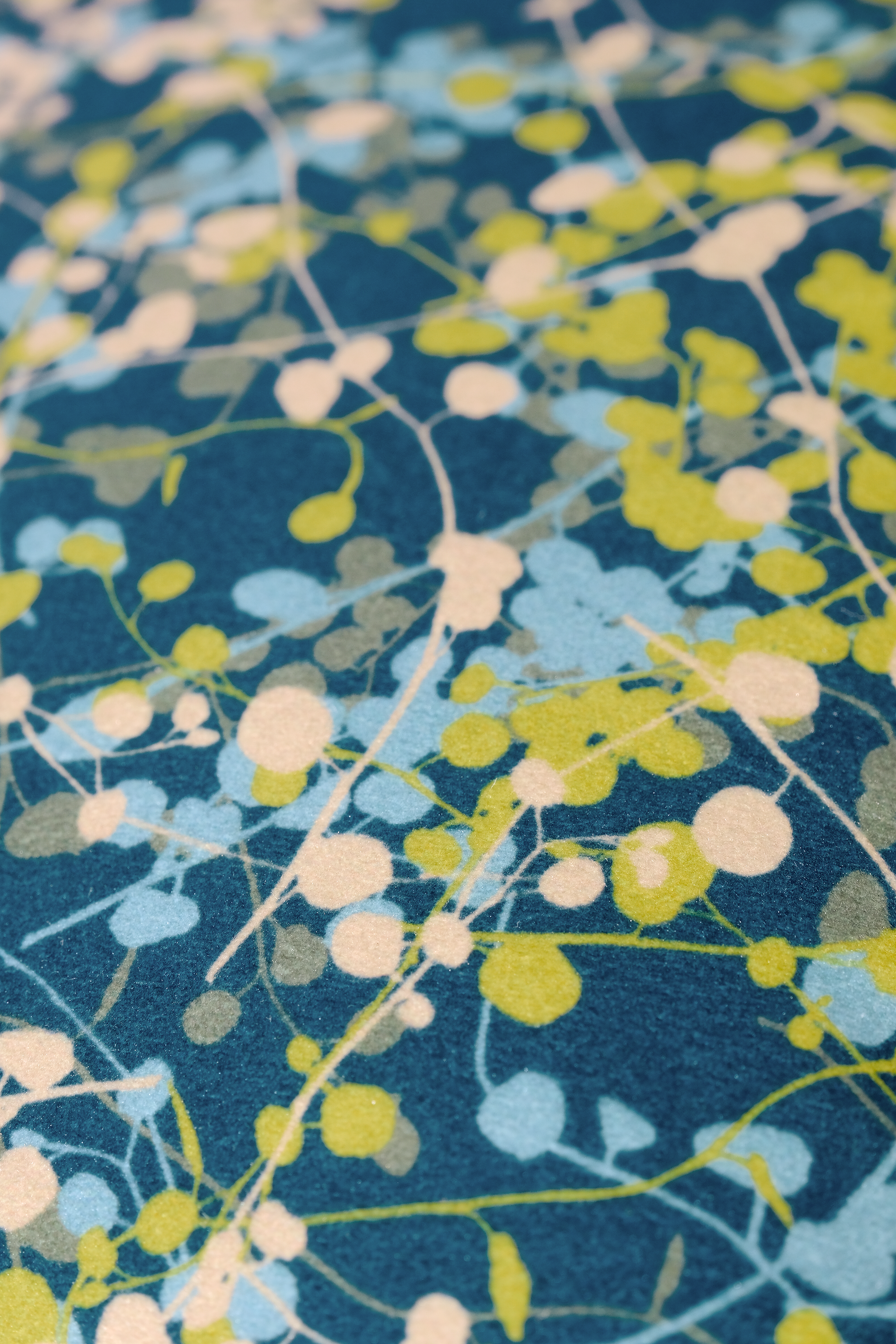 Close-up of a velvet with a leafy vine pattern on a blue background