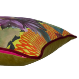 Side shot of a printed linen cushion in bright colours with a floral and geometric design