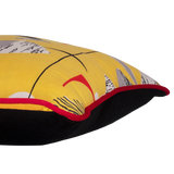 Side view of a colourful cushion made from a vintage fabric with geometric shapes on a bright yellow base.