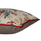 Decorative pillow with floral and bird pattern on a beige background