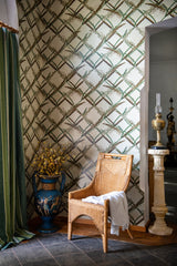 Wallpaper of vertical green reeds with wheat accents, rustic cabinet, wooden oars, and brown leather chair