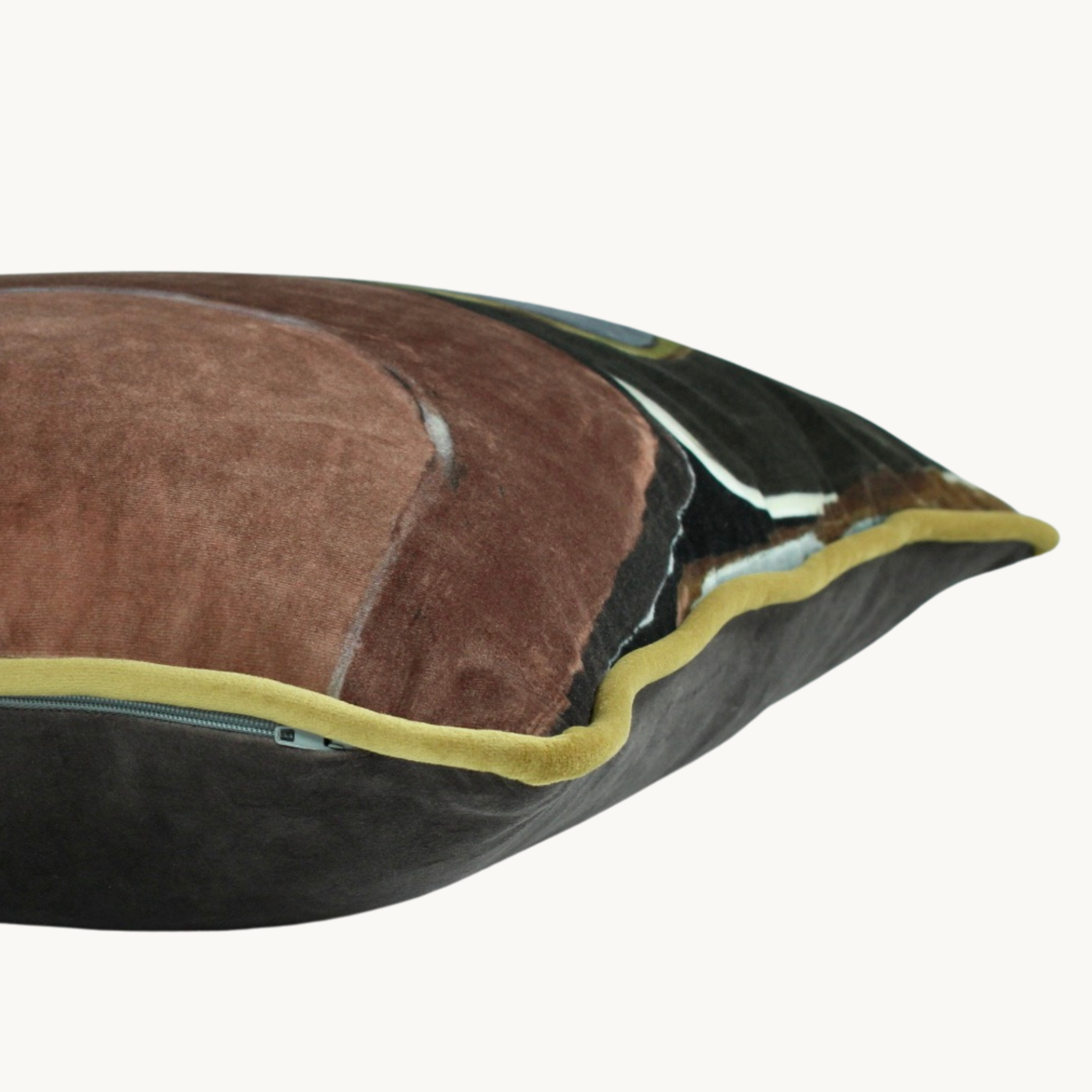 Side shot of a velvet cushion with abstract geometric shapes