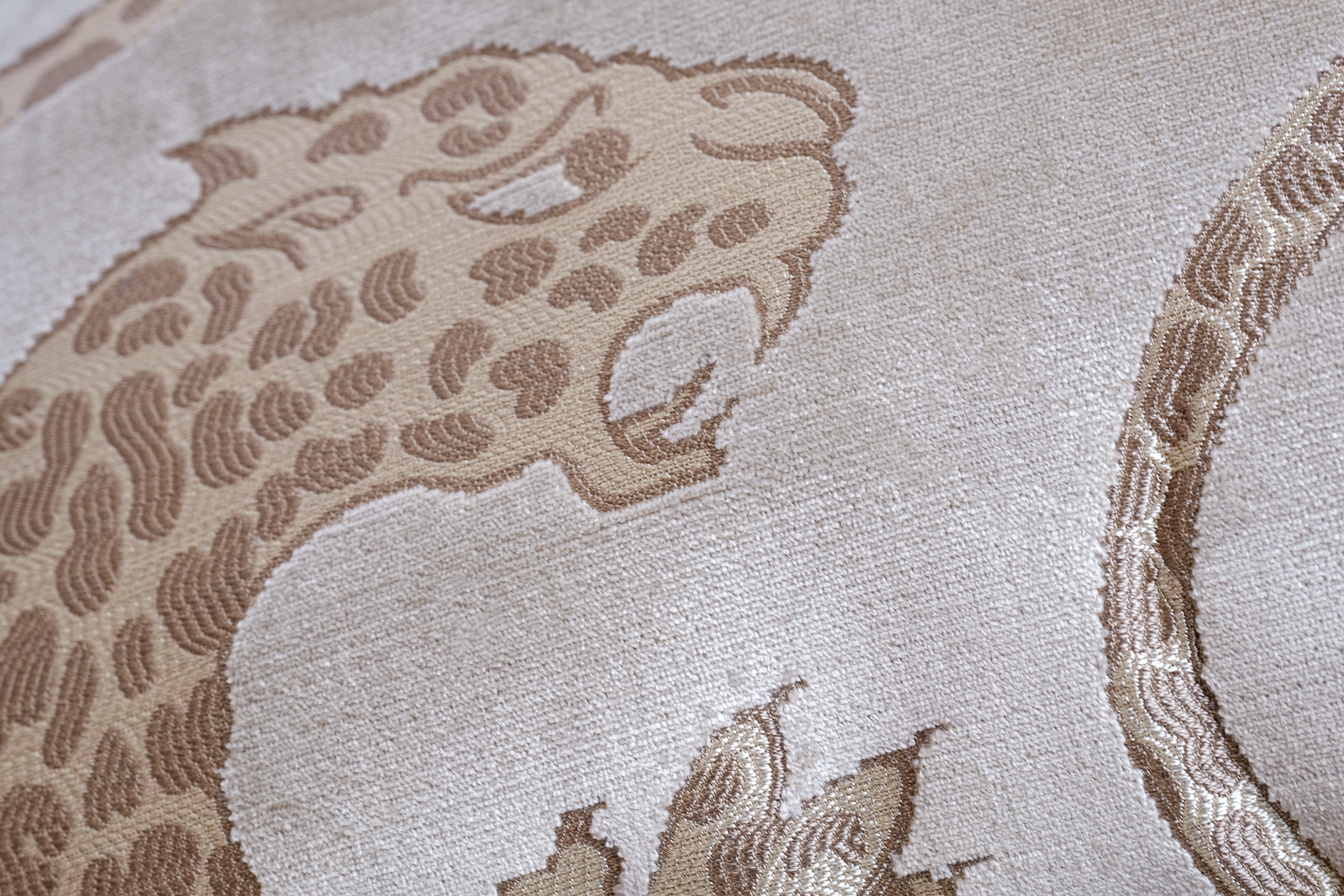 Close-up of a textured fabric with a leopard design on a beige background