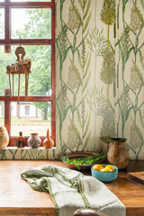 Close-up of taupe floral wallpaper with a rustic window ledge, ceramic vases, and a bowl of fresh produce.