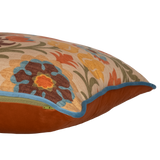 Side shot of a decorative cushion with a spanish inspired damask in autumn colours