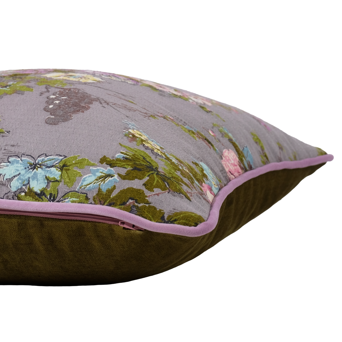 A decorative throw pillow with a floral pattern on a muted gray background, featuring a solid olive green velvet reverse side and a light pink piping trim.