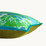 Side shot of a very bright floral cushion in lime green with periwinkle blue and violet flowers