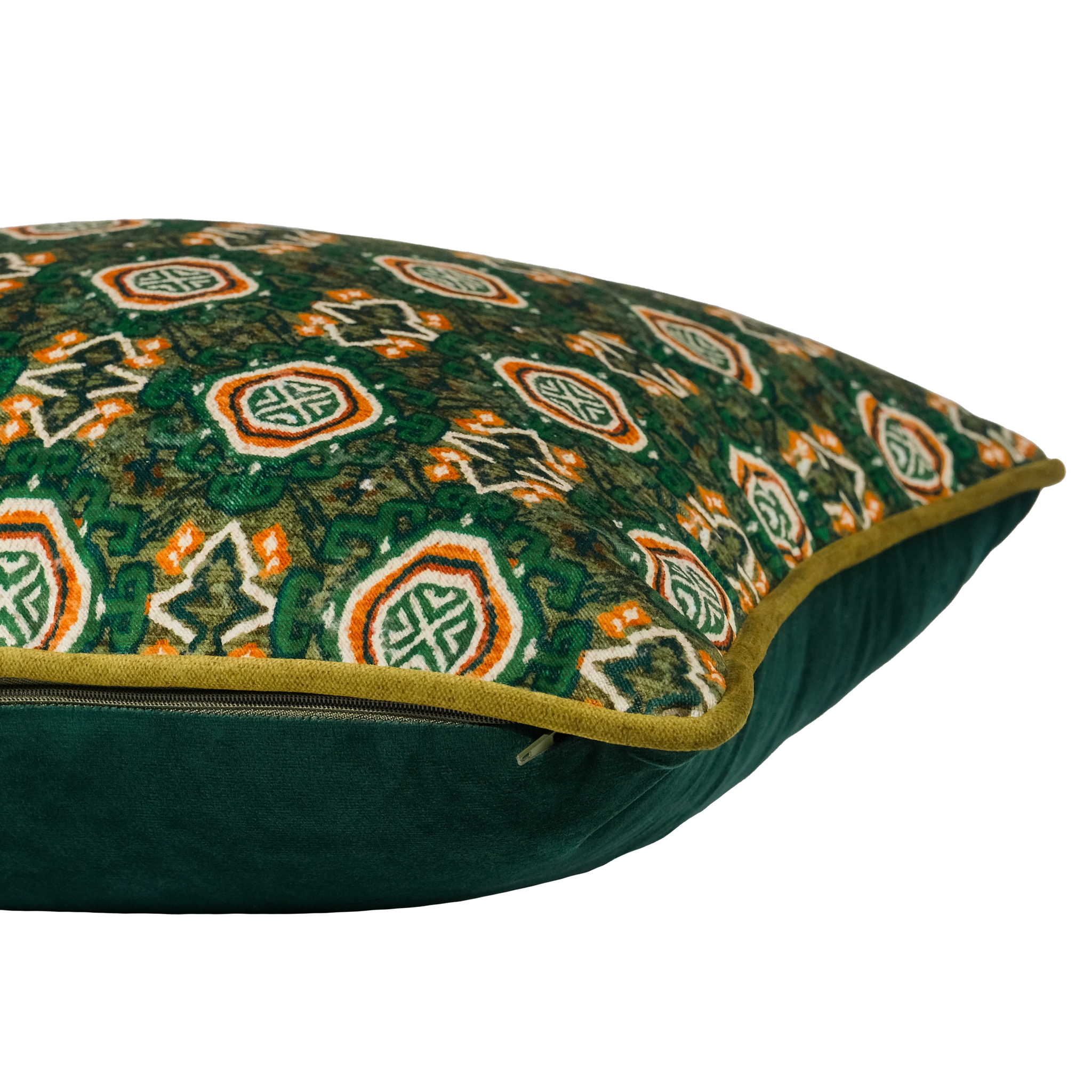 A close up of a geometric patterned throw cushion with emerald and brown coloured persian pattern and olive piping.