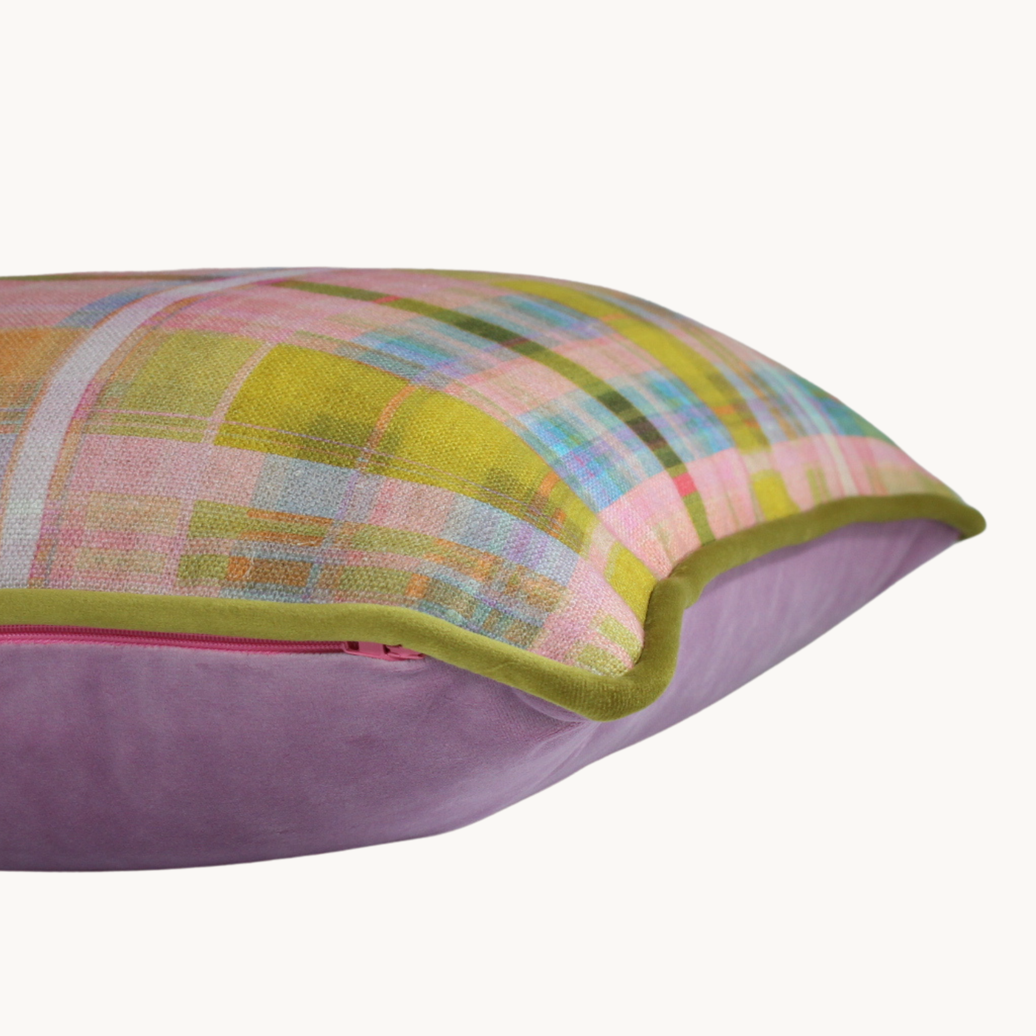 Image of a cushion with a pastel plaid front and mauve velvet back