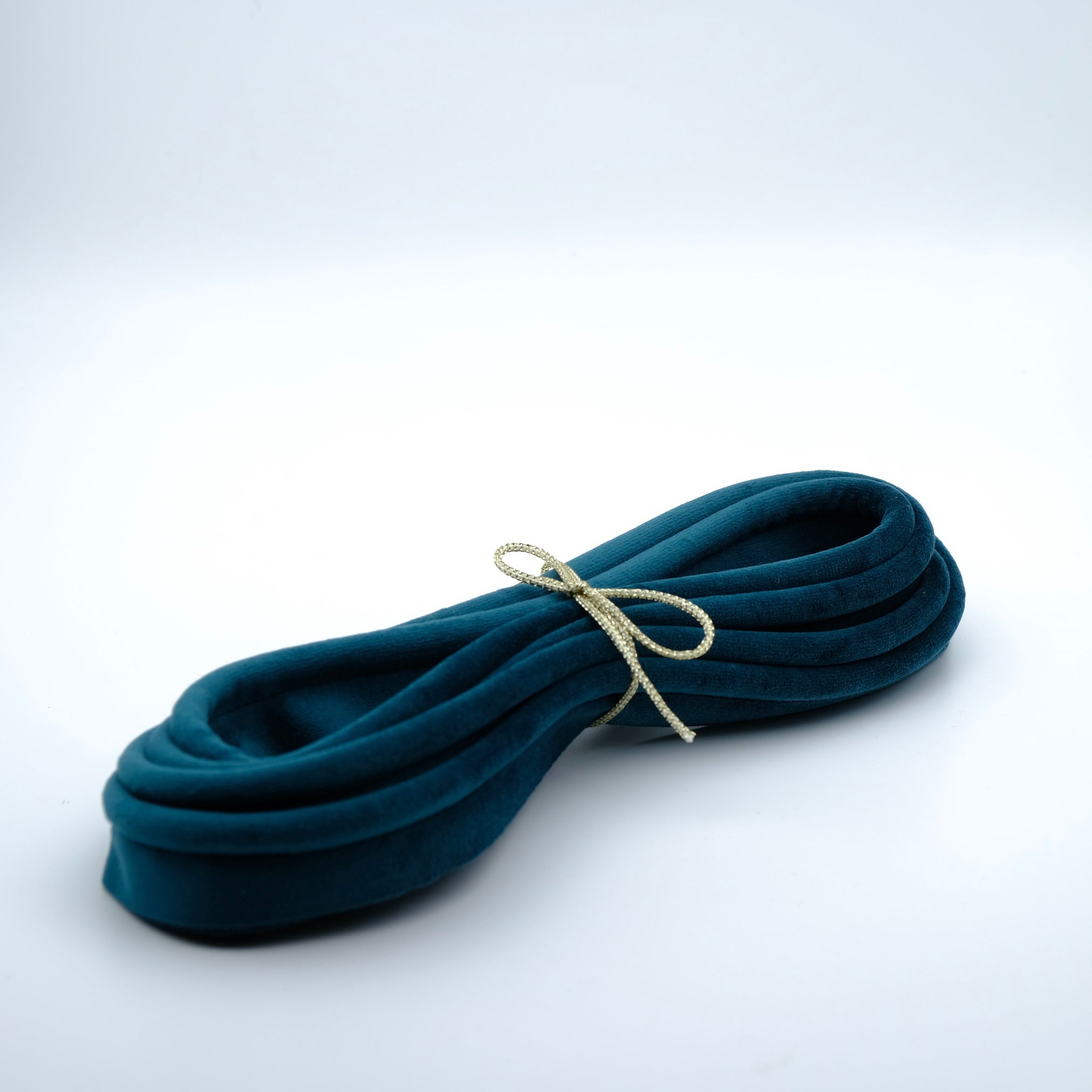 Photo of a bundle of teal coloured velvet piping cord