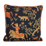 Decorative cushion with intricate patterns of animals and a person on a horse against a dark background.