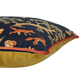 Decorative cushion with intricate patterns of animals and a person on a horse against a dark background.