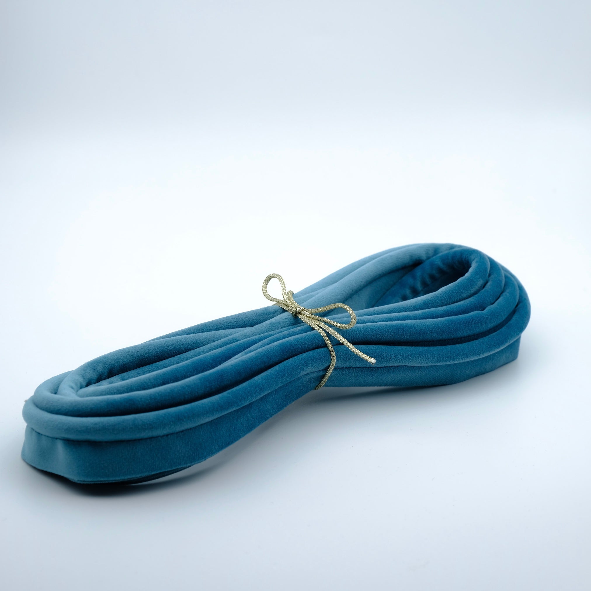 photo of a bundle of velvet piping in a topaz aqua colour