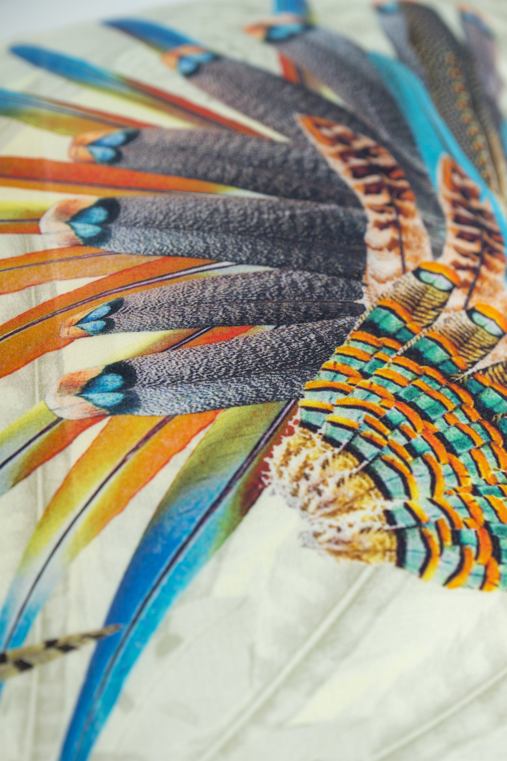 Close-up of a colorful feathered fabric with intricate details