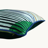 Side shot of a geometric cushion in greens and blues
