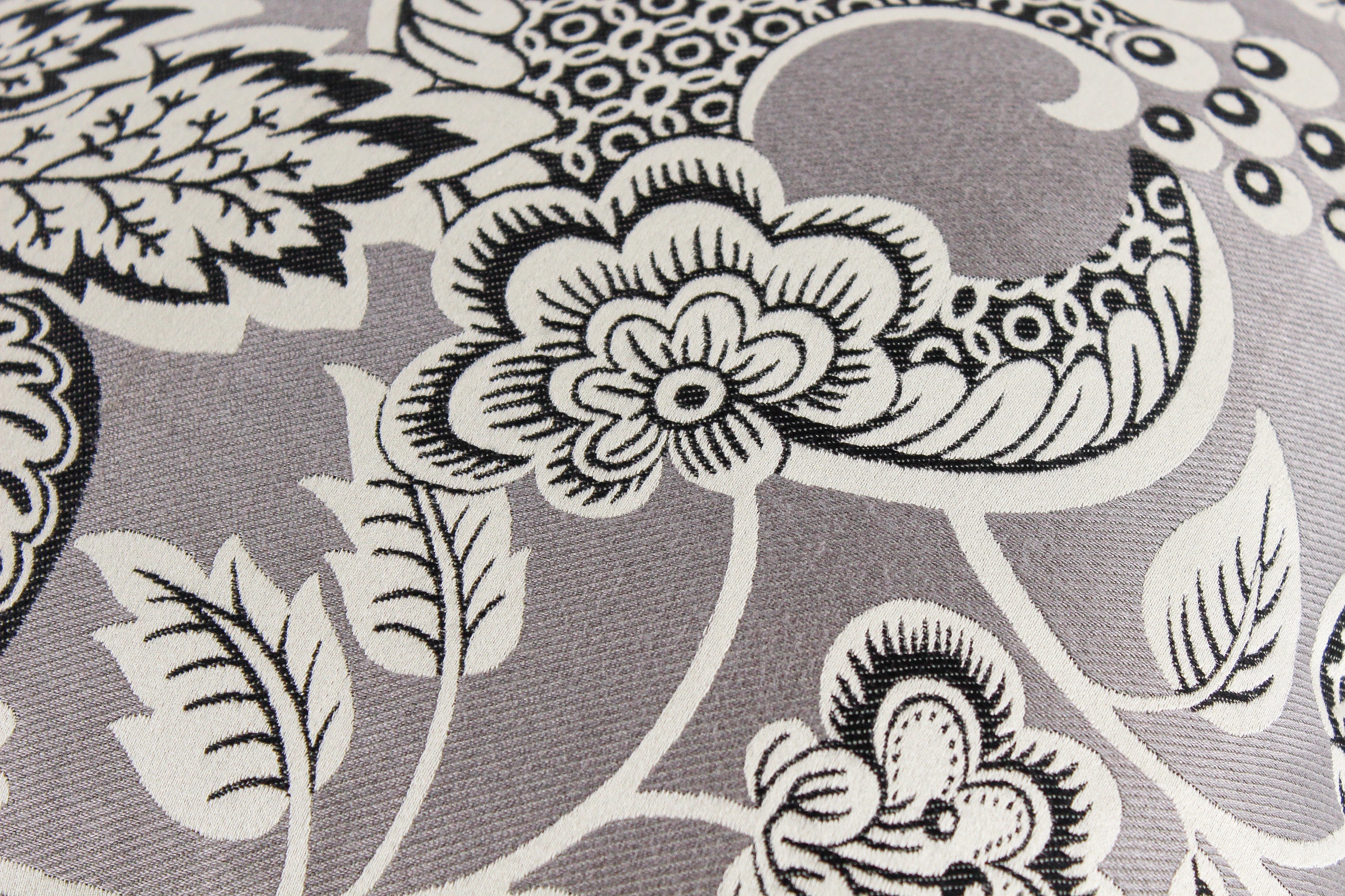 Black floral and leaf pattern on a gray background