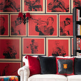 A red-toned wallpaper featuring framed portraits of jazz musicians playing instruments, accented by a black and red wall sconce and white sofa.