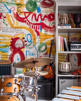 Colourful wall with music notes, scribbles, and handwritten quotes, featuring red, yellow, green, and blue strokes.
