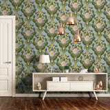 Elegant living space with botanical wallpaper featuring green pears and pink blossoms. Styled with a modern sideboard, copper pendant lights, and decor accents