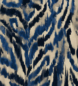 Bold zebra-print-inspired wallpaper in deep blue, black, and beige. A painterly, abstract take on animal print