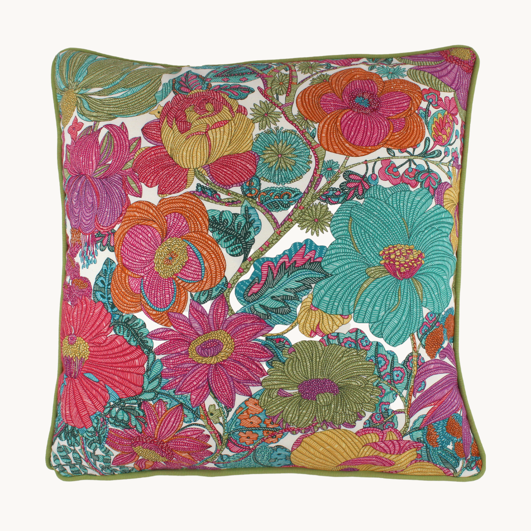 Photo of a bright colourful floral cushion with retro inspired flowers in hot pink, grape, bright turquoise, coral and orange with caper green piping