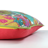 Side view of a bright colourful floral cushion with retro inspired flowers in hot pink, grape, bright turquoise, coral and orange with caper green piping and a grapefruit cotton back