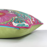 Side view of a bright colourful floral cushion with retro inspired flowers in hot pink, grape, bright turquoise, coral and orange with fuschia piping and a caper green cotton back