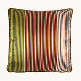 Photo of a cushion with an orange, white, green and black barcode like stripe